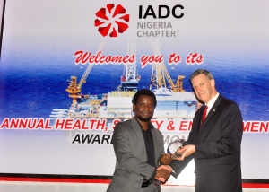 Mike DuBose, IADC Vice President, International Division presents Mr. Tunji Adenuga of Indigo Drilling with the award for best improved company during the IADC Nigeria Chapter's safety awards event.